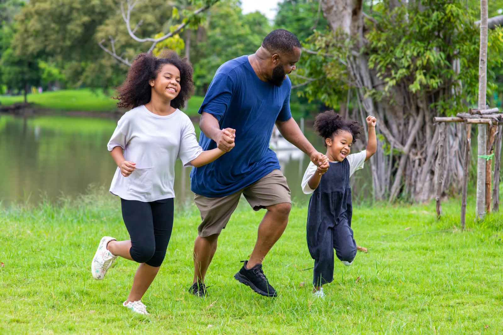 A happy family running together across a park