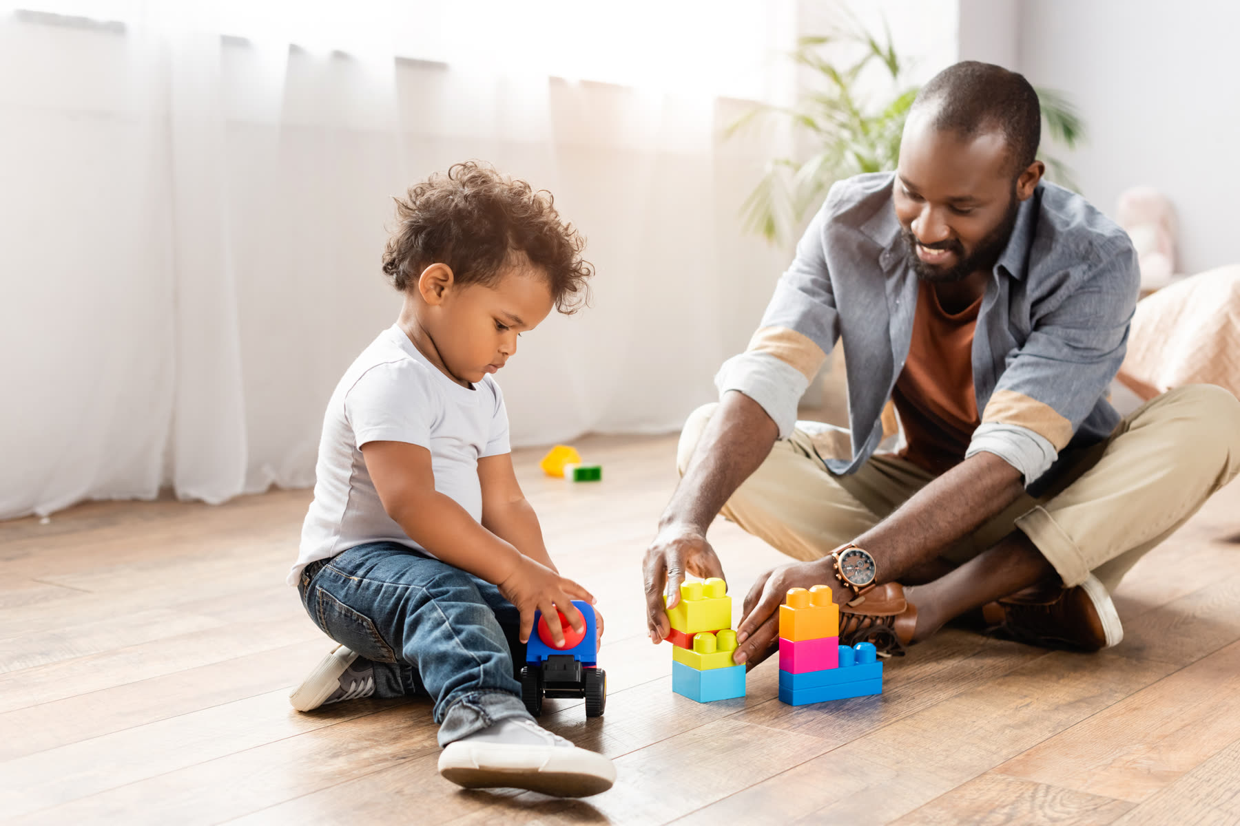 A father building blocks with his young son