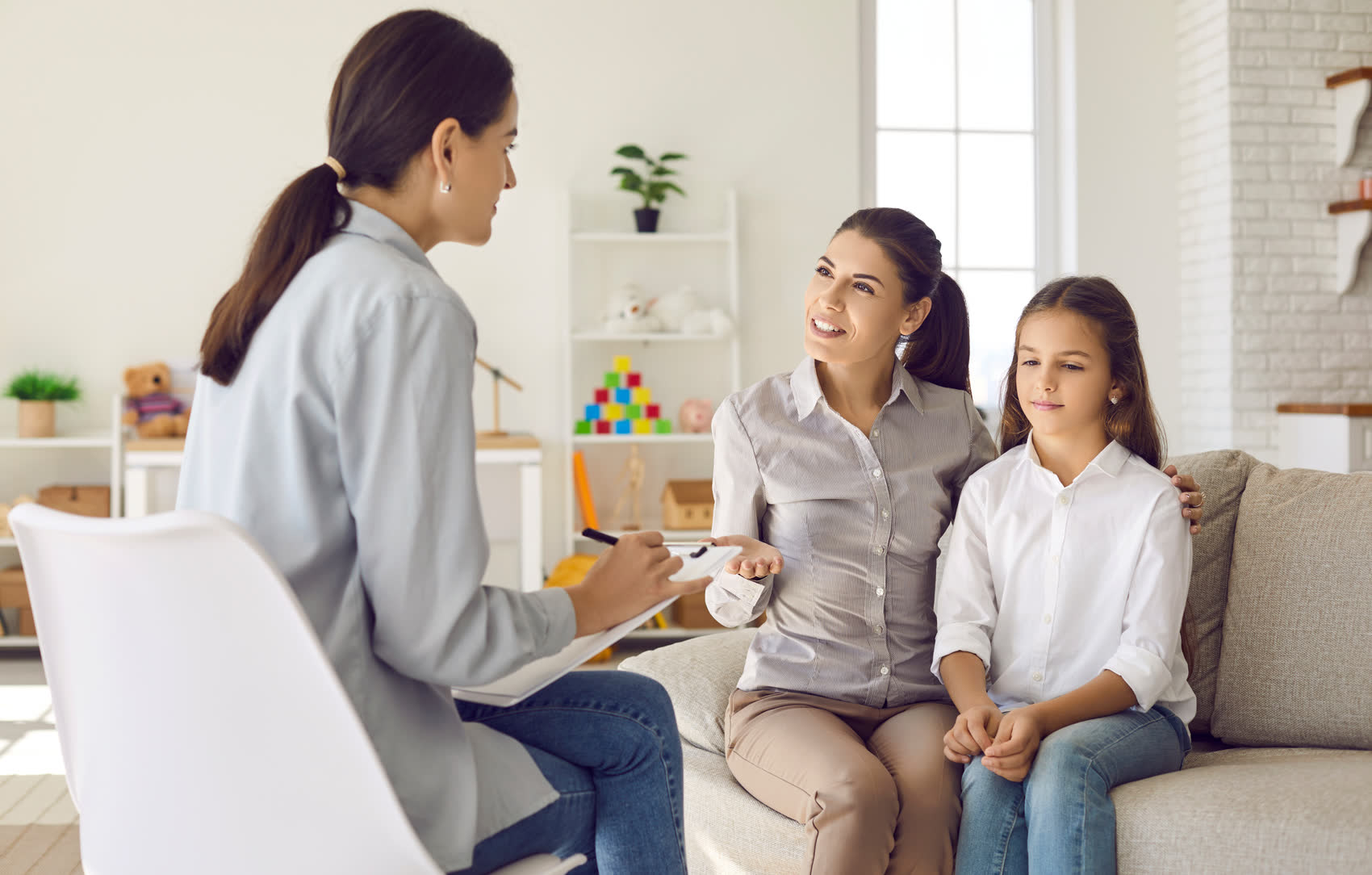 A mother and daughter talking with a family counselor